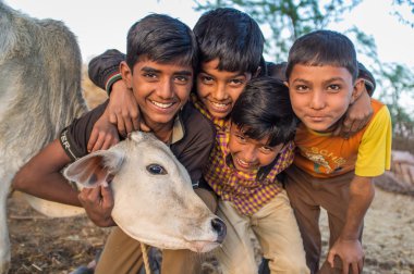 boys from Rabari tribe and calf pose.