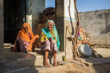 Two elderly women sit