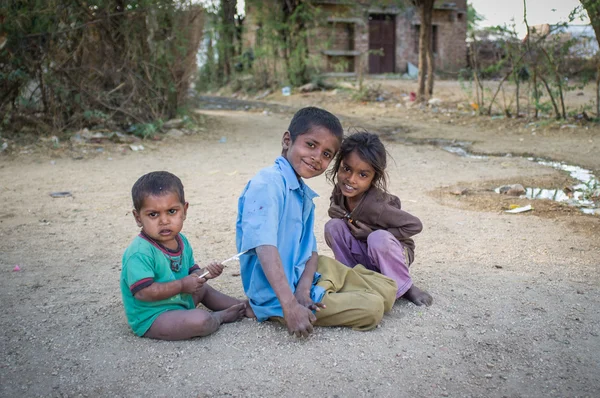 Three kids sit and play — Stok fotoğraf