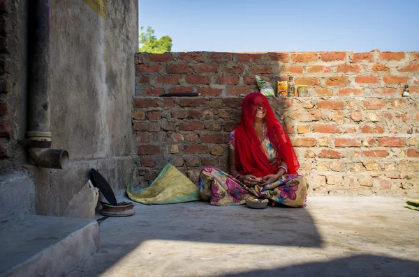 Woman in sari sits — стокове фото