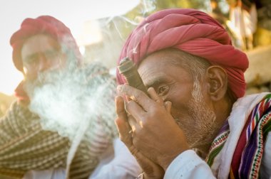 Rabari tribesman smokes