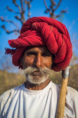 Rabari tribesman stands on field