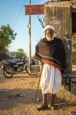 Elderly tribesman stands