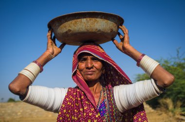 Rabari tribeswoman stands in field