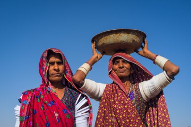 Rabari tribeswomen stand in field