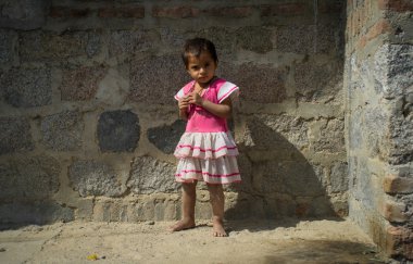 Indian girl stands alone