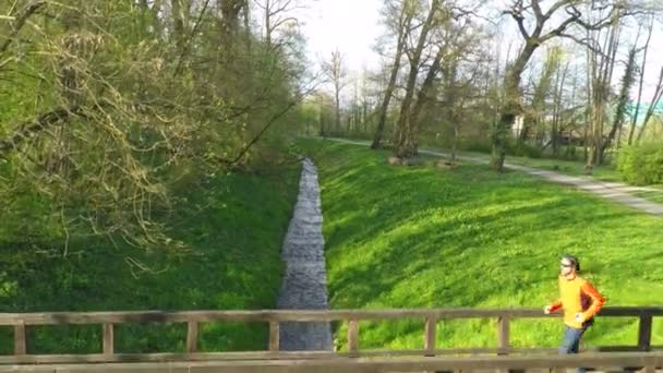 Man running across the bridge — Stock Video