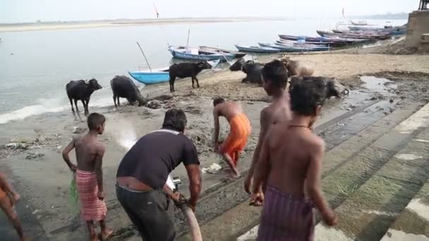 Мужчина смывает водой из шланга — стоковое видео