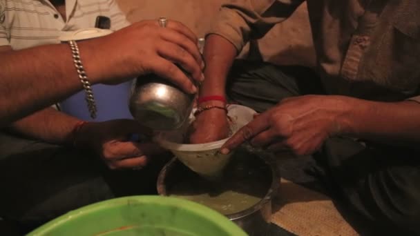 Indian men filtering liquid — Stock Video