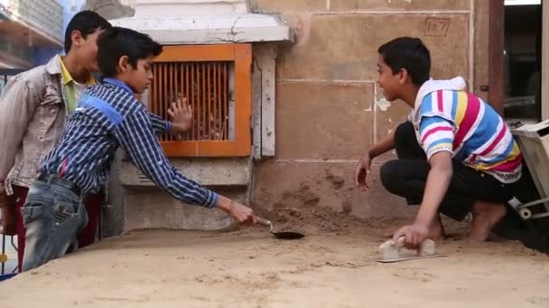 Indian boys realigning sand — Stock Video