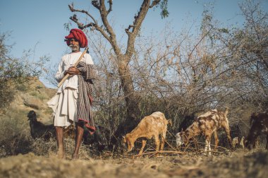 Rabari tribesman holds traditional axe