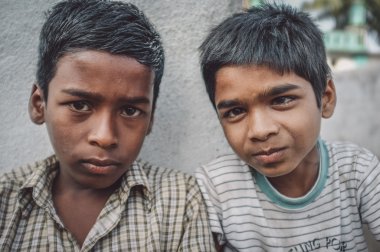 two Indian boys sit