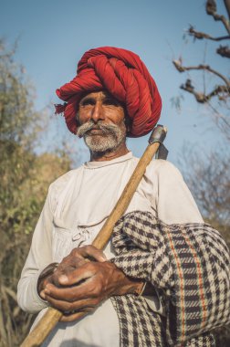 Rabari tribesman holds traditional axe