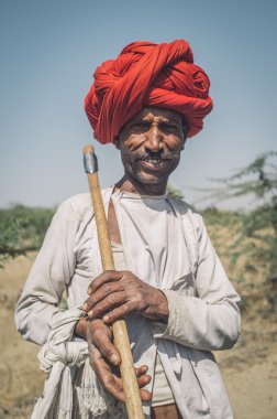 Rabari tribesman holds traditional axe