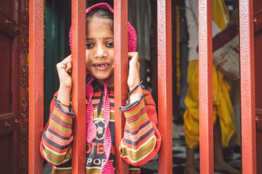 girl  looks through closed fence