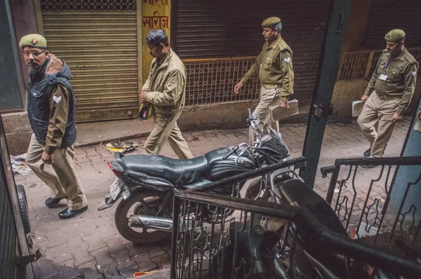 Policemen walk on street — Stok fotoğraf