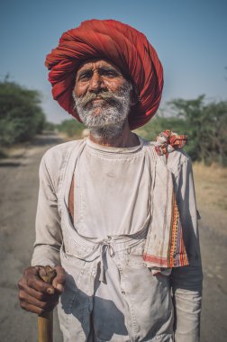 Rabari tribesman holds traditional axe
