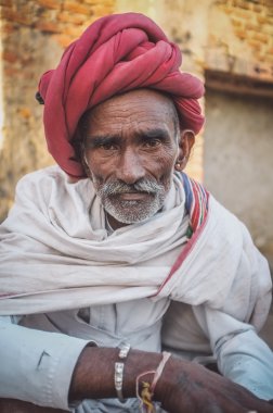 tribesman with red turban posing