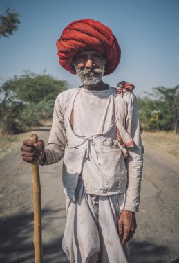 tribesman with big red turban standing