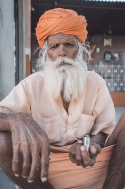 Elderly tribesman sitting  on ground