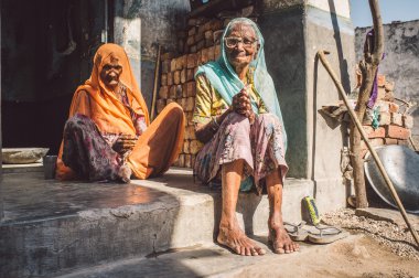 Two elderly women sit