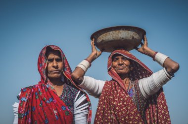 tribeswomen stand in field