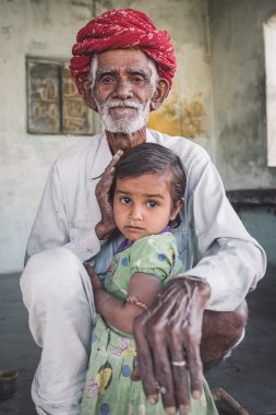 Rabari tribesman holds granddaughter