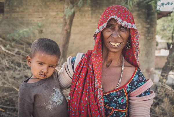 Elderly Indian woman holds baby — Stock Photo, Image