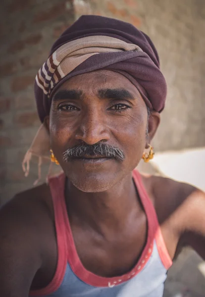 Mechanic with mustache sits — Stock fotografie