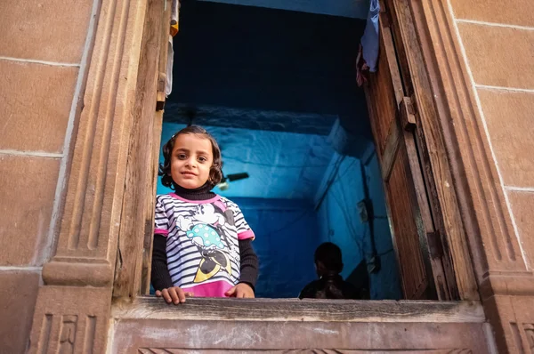 girl looking through window