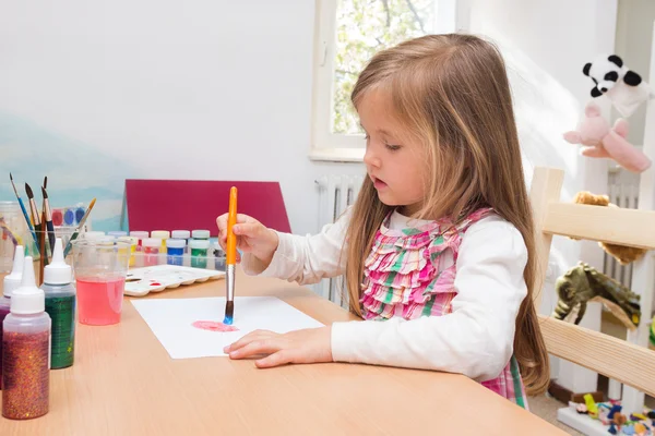 Little blonde girl painting — Stock Photo, Image