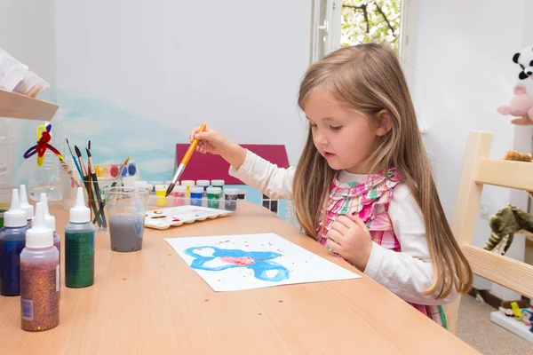 Little blonde girl painting — Stock Photo, Image