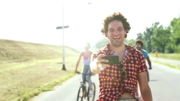 Adults cycling and taking selfies — Stock Video