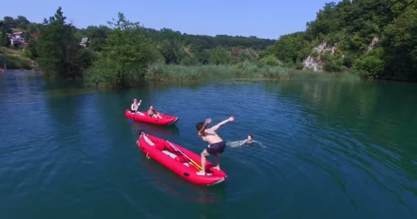 Man doing backflip from a canoe — Stock Video