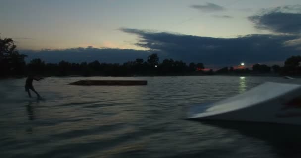 Wakeboarder jumps over the kicker — Stock Video