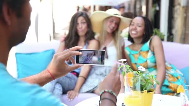 Man's hands taking pictures of women — Stock Video