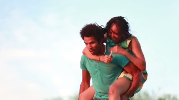 Man giving girlfriend a piggyback ride — Stock Video