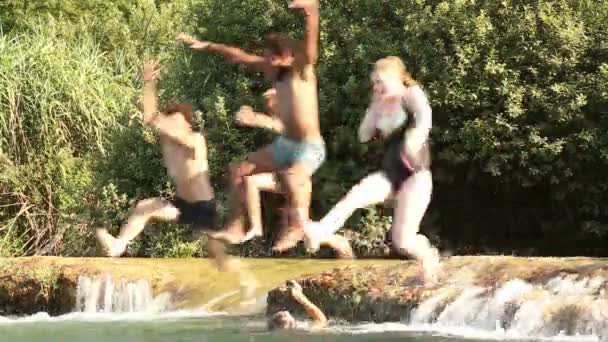 Freunde beim Sprung in Fluss — Stockvideo