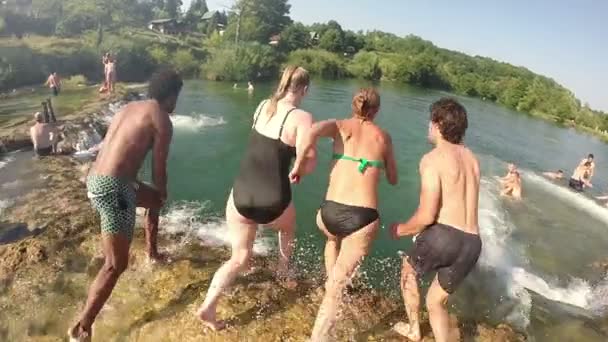 Friends jumping into river — Stock Video