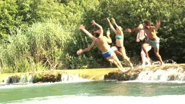 Friends jumping into river — Stock Video