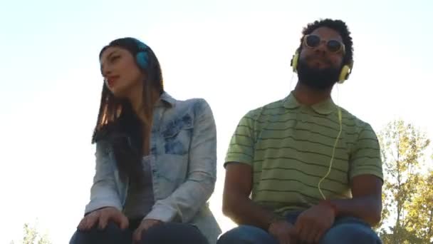 Pareja escuchando música con auriculares — Vídeo de stock