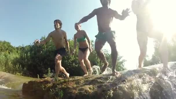 Friends jumping into river — Stock Video