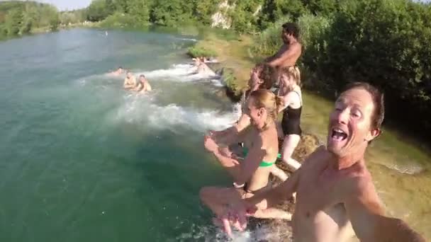 Uomo che salta nel fiume con gli amici — Video Stock