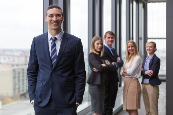 Young businessman with colleagues — Stock Photo, Image