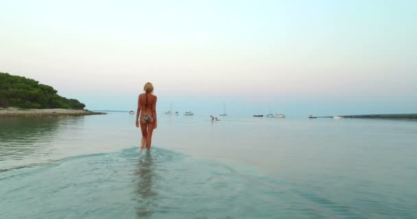 Woman entering into sea — Stock Video