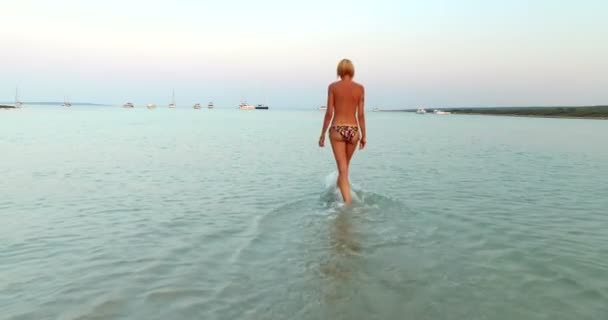 Woman entering into sea — Stock Video