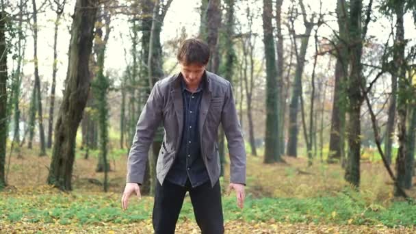 Man throwing leaves in the air — Stock Video