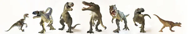 Un gruppo di sette dinosauri in fila Foto Stock