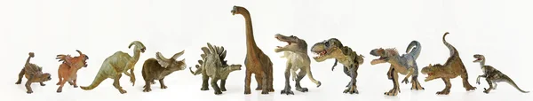 Un gruppo di undici dinosauri in fila Foto Stock