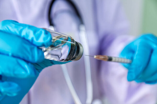 Vials and syringe on light background. Vaccination and immunization.